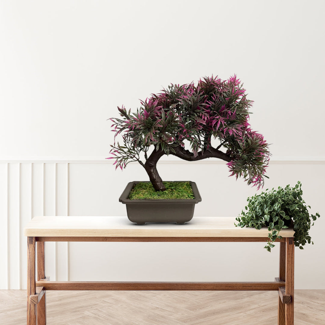 Faux bonsai tree with natural-looking foliage in a decorative planter